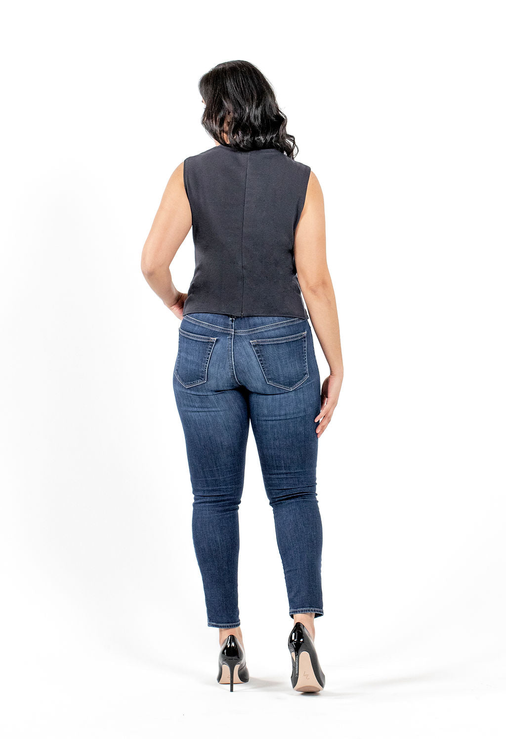 back view of sustainable sleeveless professional black blouse and jeans